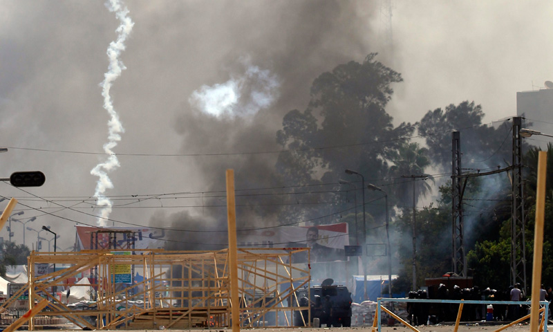 Tear gas and smoke cloud the site of the protest.