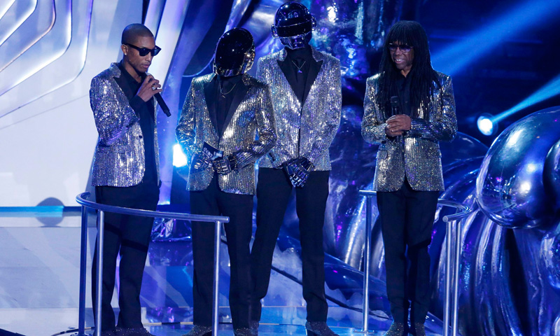 Daft Punk (centre), with Pharrell Williams (left) and Nile Rogers (right) stand on stage. –Photo by Reuters
