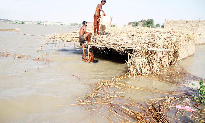 Residents of Katcha area collect remaining items from their submerged homes. – Online photo