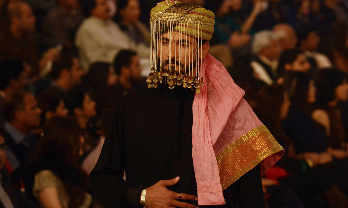 A Pakistani model presents a creation by designer Fahad Hussayn. – Photo by