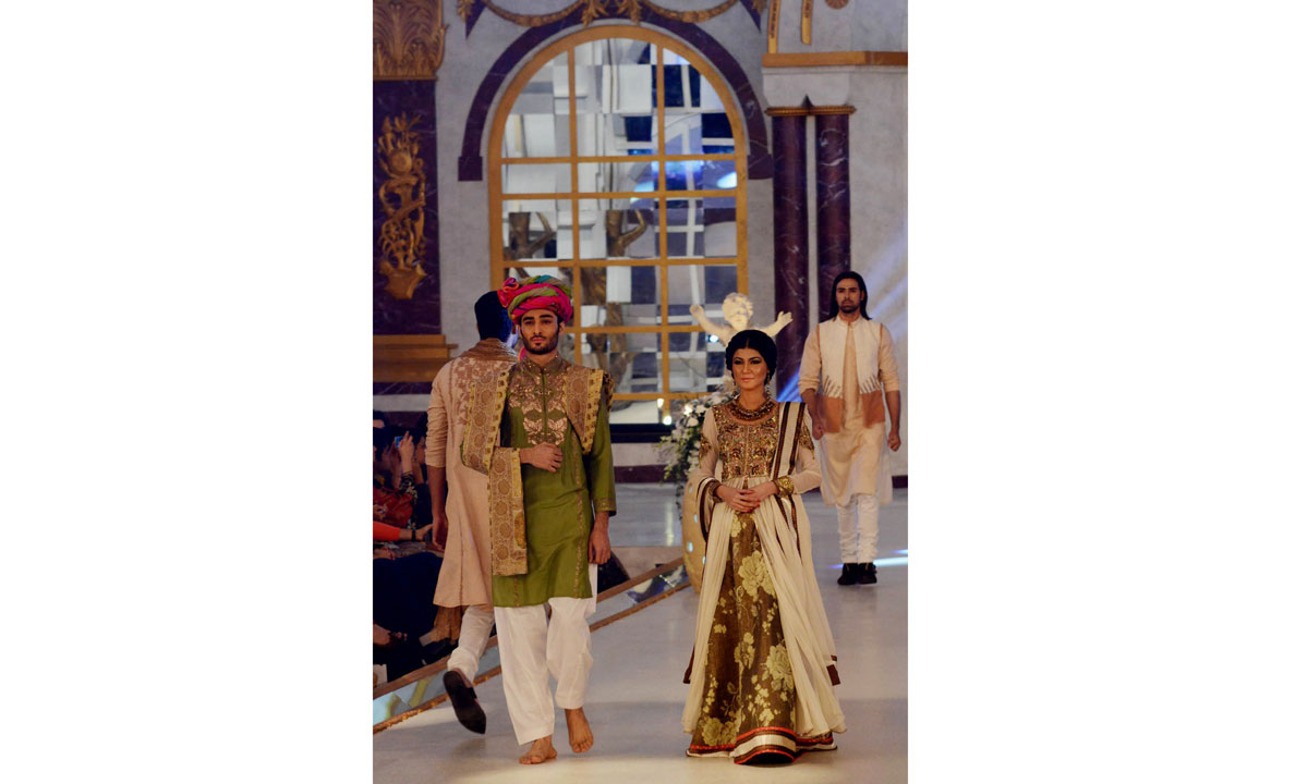 Pakistani models present creations by designer Fahad Hussayn. – Photo by AFP