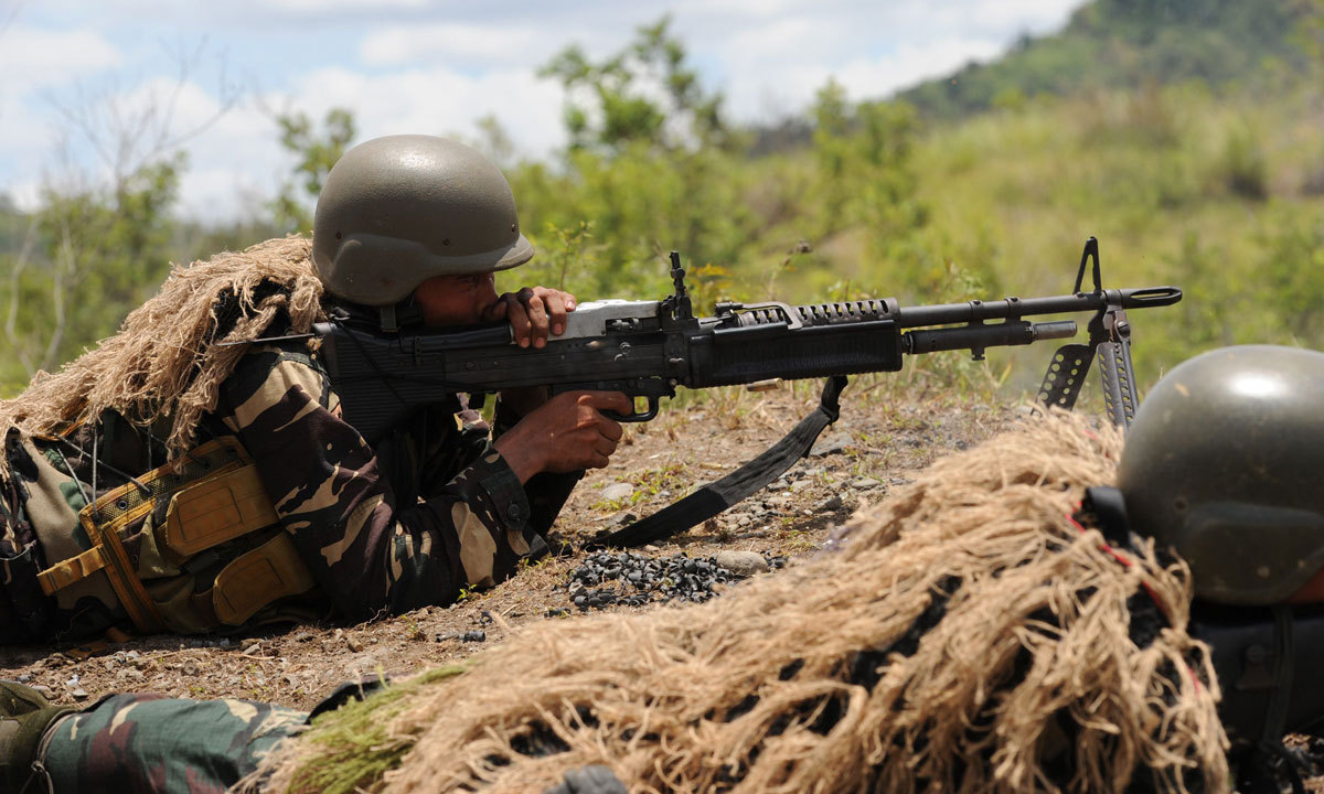 A Philippine soldier fires a machine gun during a live fire exercise at Fort Magsaysay, in Nueva Ecija province north of Manila on May 10, 2014. – Photo by AFP