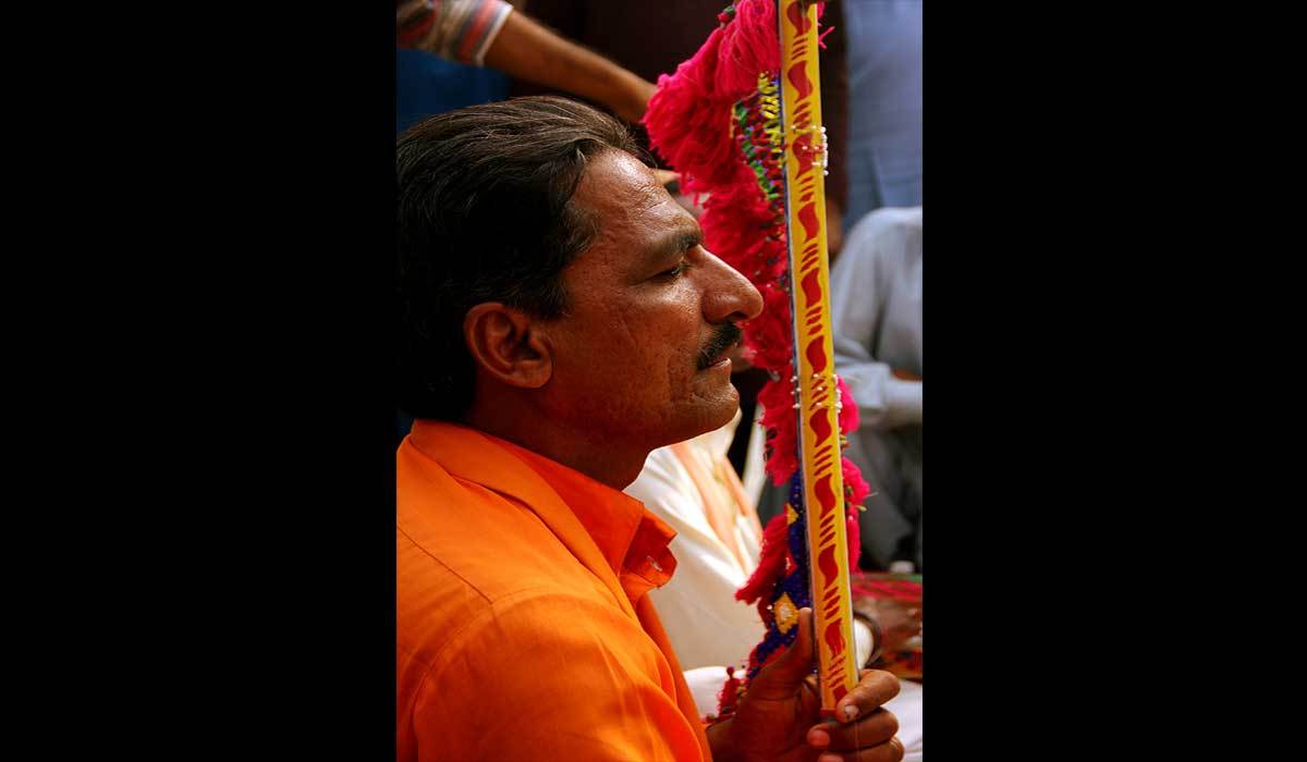 A musician plays his instrument, lost in the mystical aura and rhythm, at the tomb of the great sindhi sufi Sachal Sarmast. Khairpur, Sindh. – Photo by Arman Tejani
