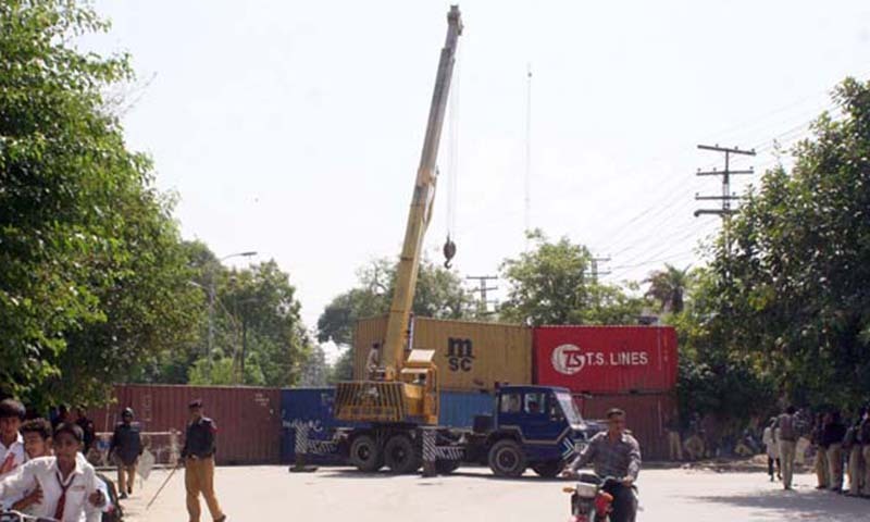 Policemen moving containers in Lahore. — File photo
