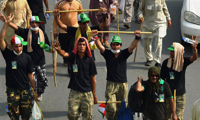 — AFP Photo shows supporters of Tahirul Qadri brandishing sticks as they make their way from Lahore to Islamabad