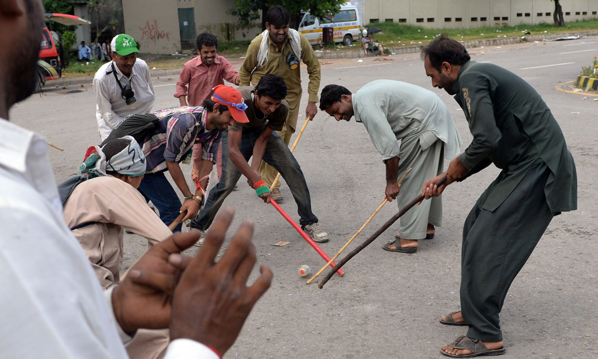 Supporters of Tahirul Qadri and Imran Khan play near the prime minister's residence during an anti-government protest in Islamabad. - Photo by AFP