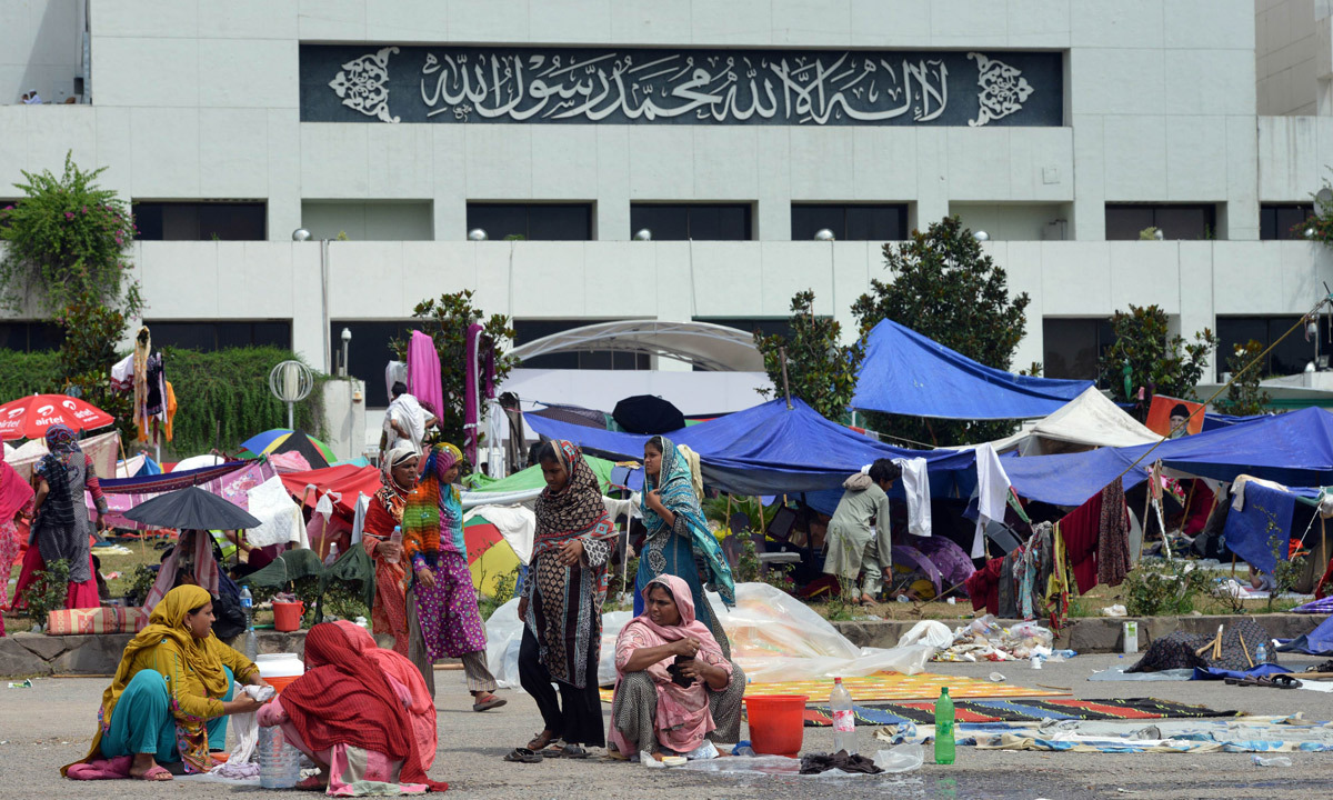 Supporters of Tahirul Qadri wash clothes during an anti-government protest near the prime minister's residence in Islamabad. - Photo by AFP