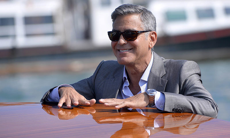 US actor George Clooney takes a taxiboat upon his arrival in Venice, on the eve of his wedding. -Photo by AFP