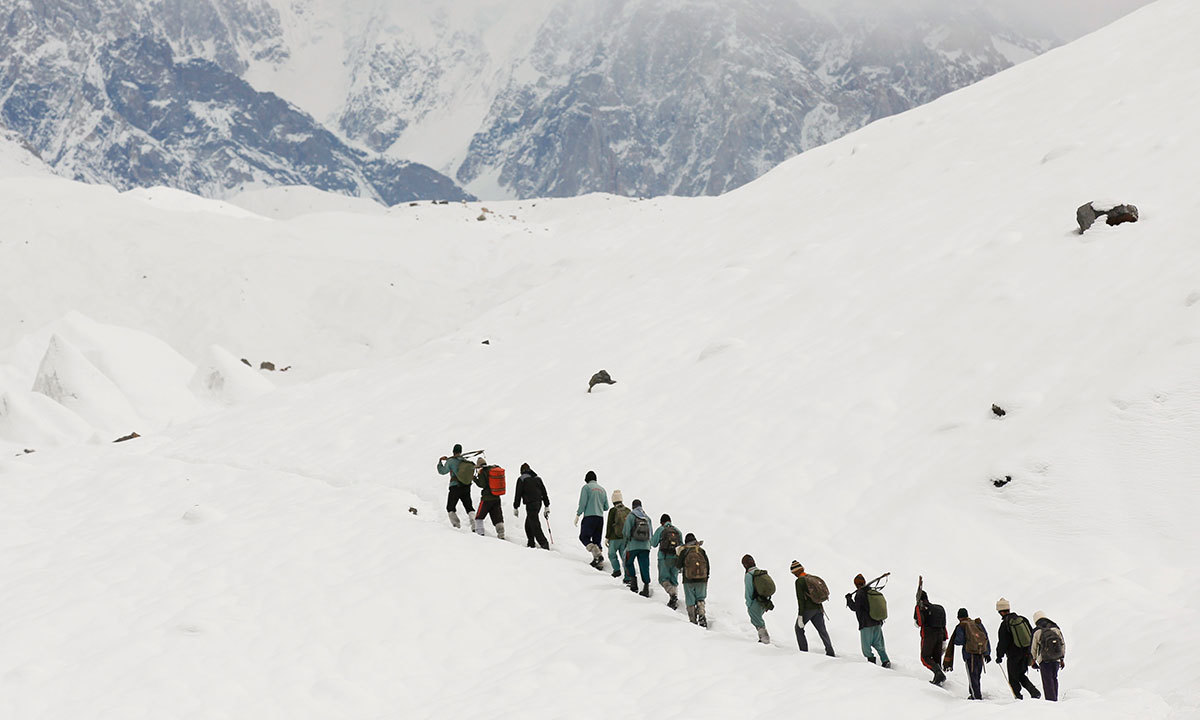 A group of Pakistani soldiers carry their guns uphill along the K2 base camp trek in the Karakoram mountain range in Pakistan. -Reuters Photo