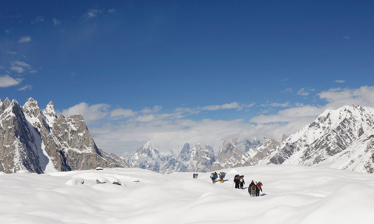 Trekkers and porters hike down the Baltoro glacier in the Karakoram mountain range in Pakistan. -Reuters Photo