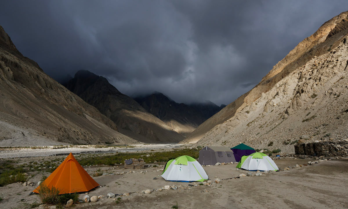 Tents stand under dark rain clouds in the valley of the river Braldu at Bardoumal near the Baltoro glacier in the Karakoram mountain range. -Reuters Photo