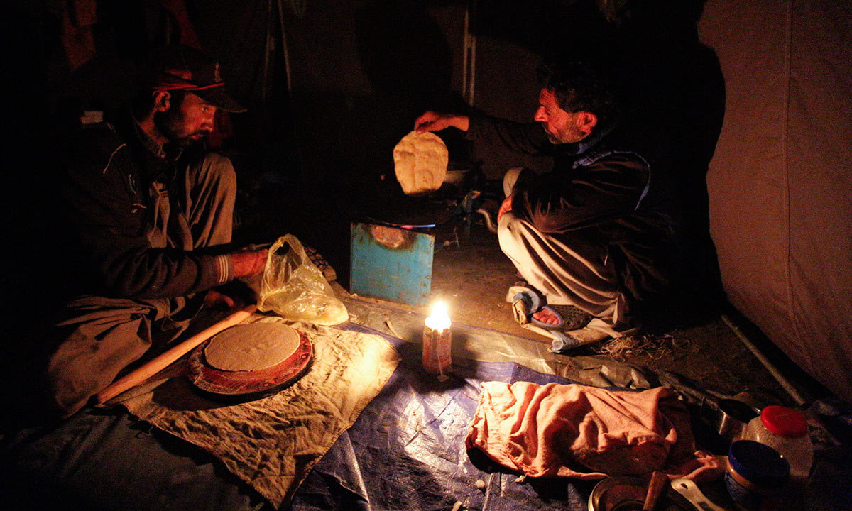 Shukrullah Baig, a 52-year-old brick layer and former cook at a five-star hotel chain cooks a chapati in the village of Askole in the Karakoram mountain range in Pakistan. -Reuters Photo