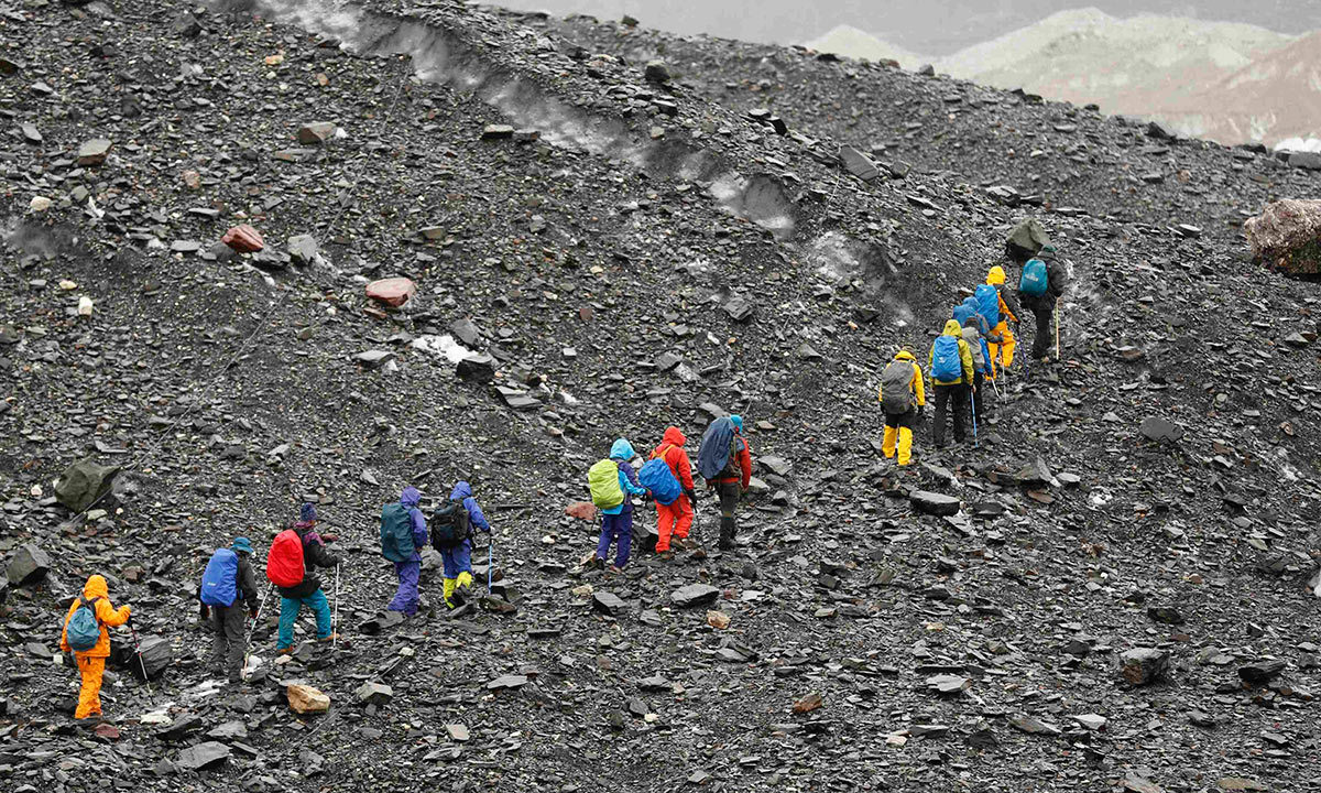 A group of Japanese trekkers climb the rock-covered Baltoro glacier in the Karakoram mountain range. -Reuters Photo