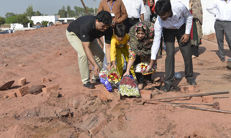  Relatives lay flowers at the site of the murder of the Christian couple at a brick kiln in Kot Radha Kishan, some 60 kilometres (40 miles) southwest of Lahore on November 5 - AFP 