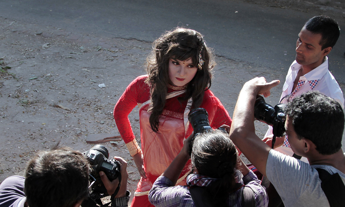 A participant poses for photographers. — AP Photo