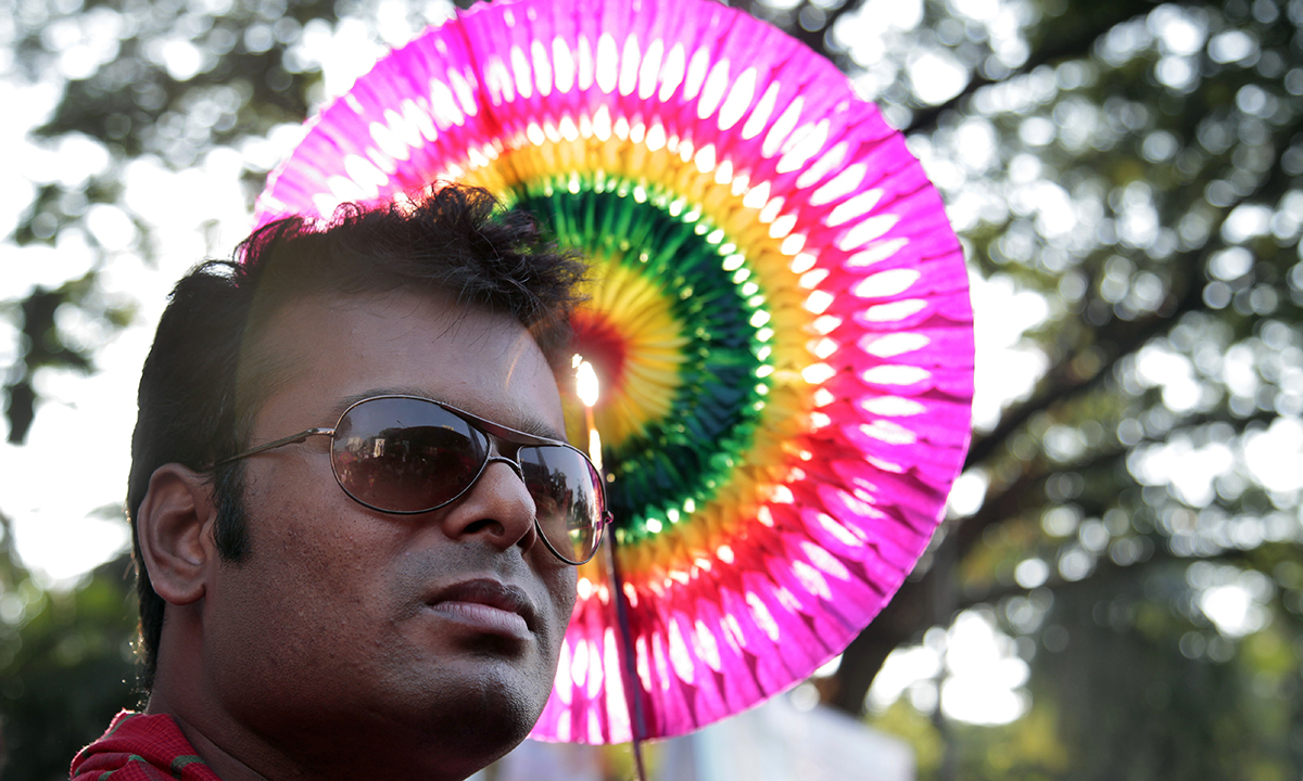 A participant holds a colorful hand fan at the rally.— AP Photo
