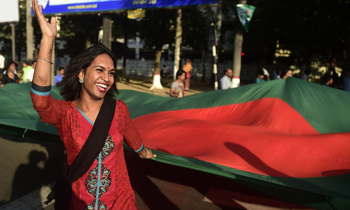 Transgenders hold the country's national flag.— AFP Photo