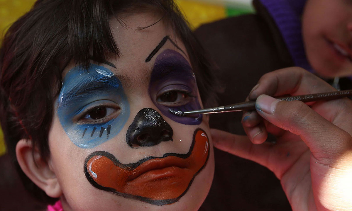 Sadaf, 6, gets his face painted at Afghanistan's first amusement park called City Park in Kabul. — AP