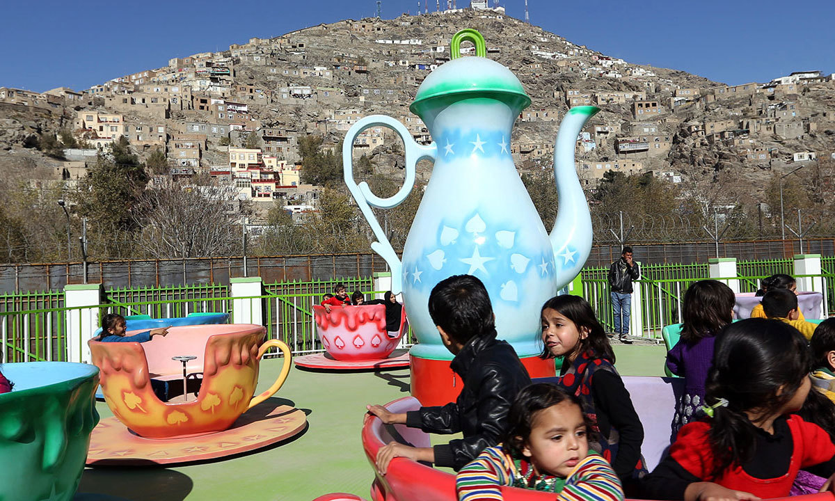 Children enjoy a spinning teacup ride at Afghanistan's first amusement park called City Park in Kabul. — AP
