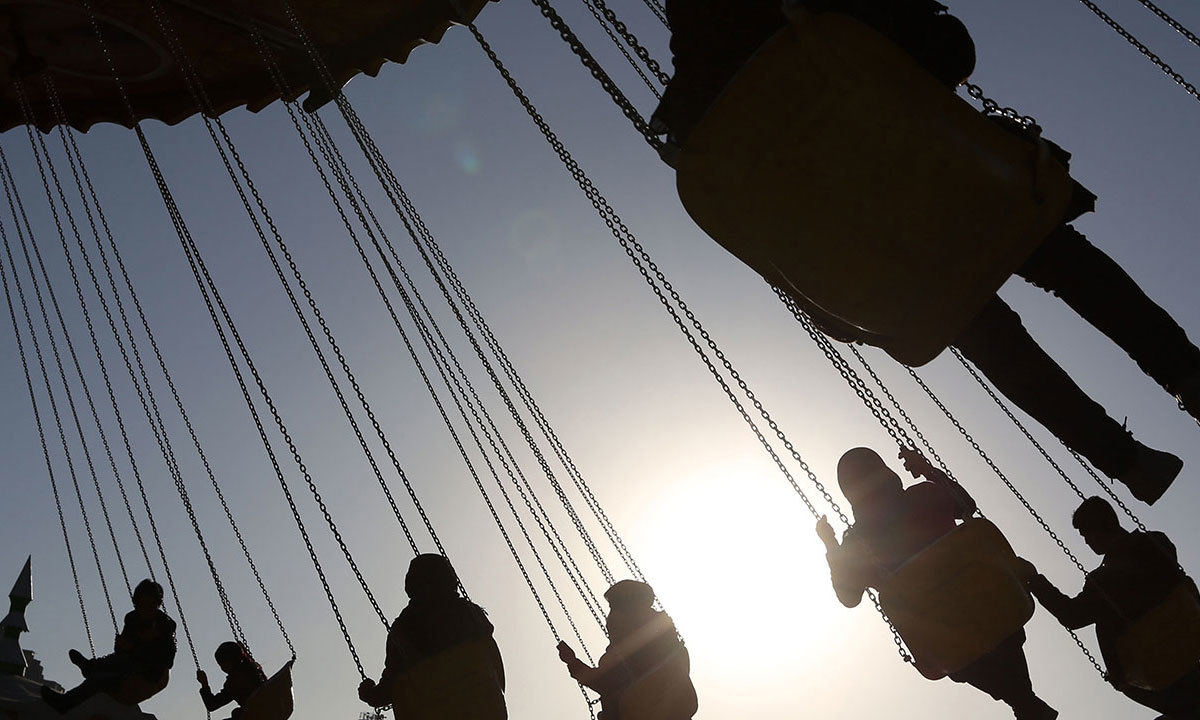Visitors enjoy a spinning chair ride at Afghanistan's first amusement park called City Park in Kabul. — AP