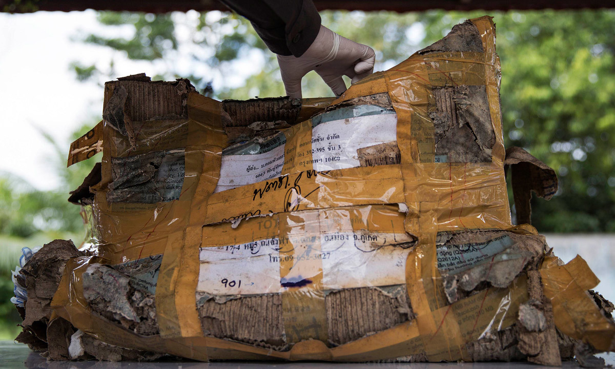  A policeman opens a box with personal possessions of 2004 tsunami victims to be photographed outside a police station in Takua Pa, in Phang Nga province, Thailand. – REUTERS 