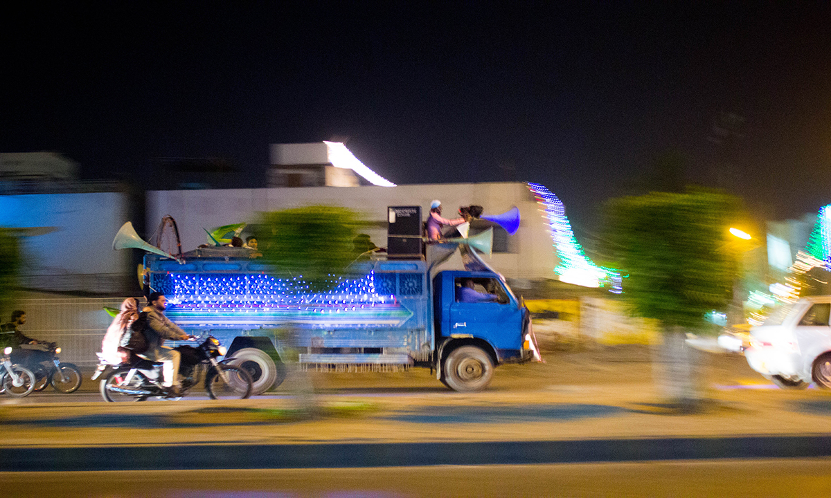 A truck takes rounds on MA Jinnah with various Naats playing through the speakers. — Muhammad Umar A truck takes rounds on MA Jinnah with various Naats playing through the speakers. — Muhammad Umar