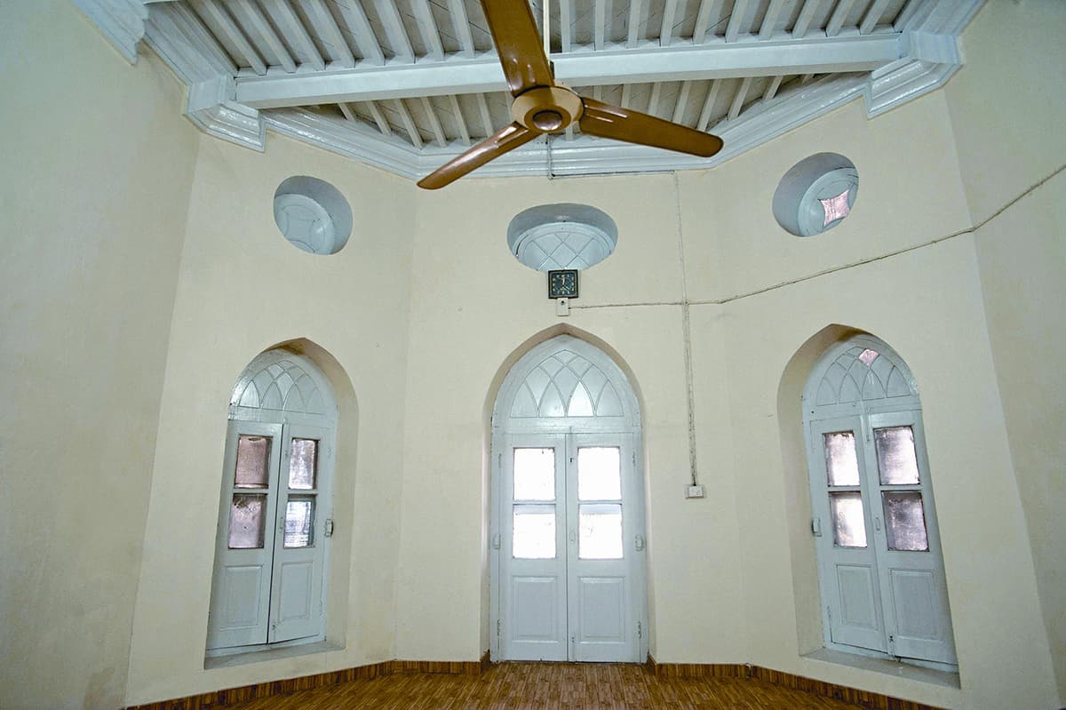 A recently renovated room with whitewashed walls is being used as the office of