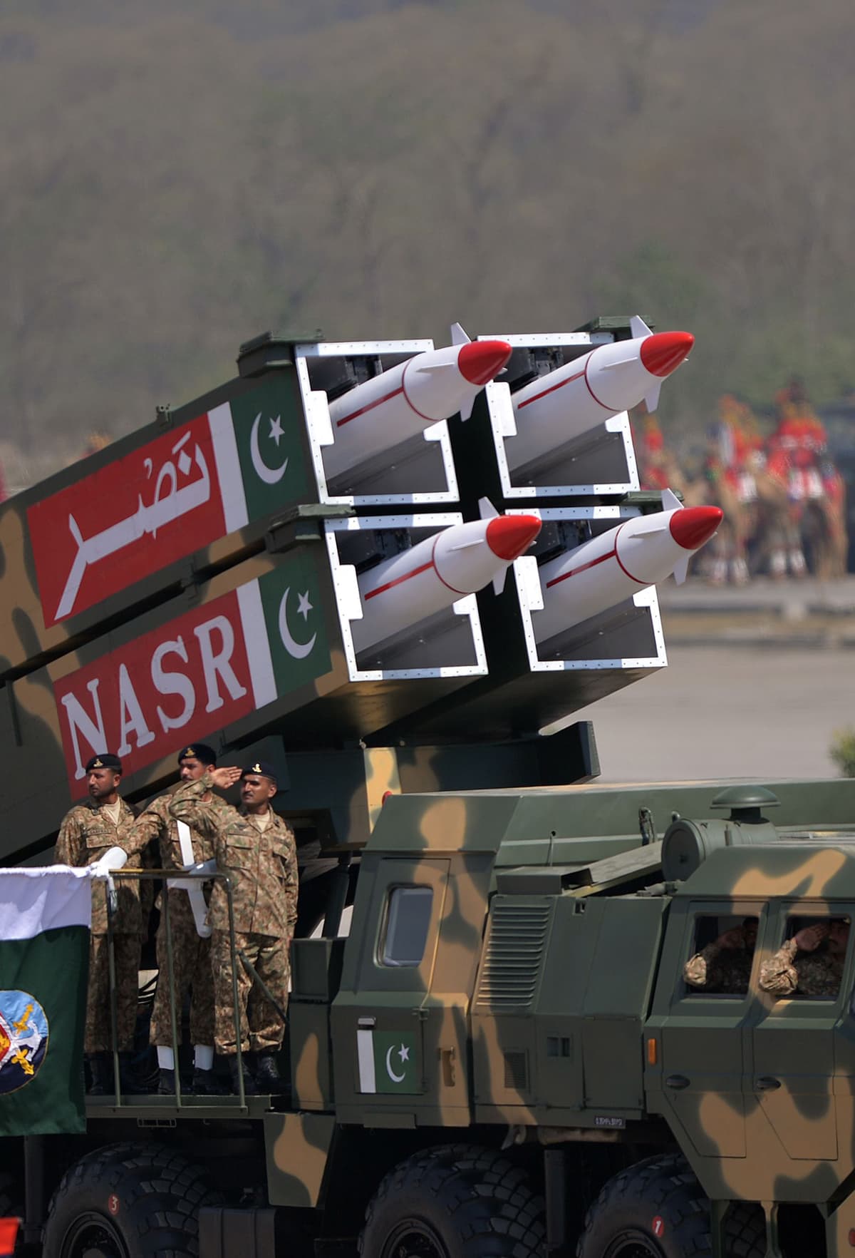 Military personnel stand beside short-range Surface to Surface Missile NASR during the Pakistan Day military parade in Islamabad on March 23, 2015. — AFP