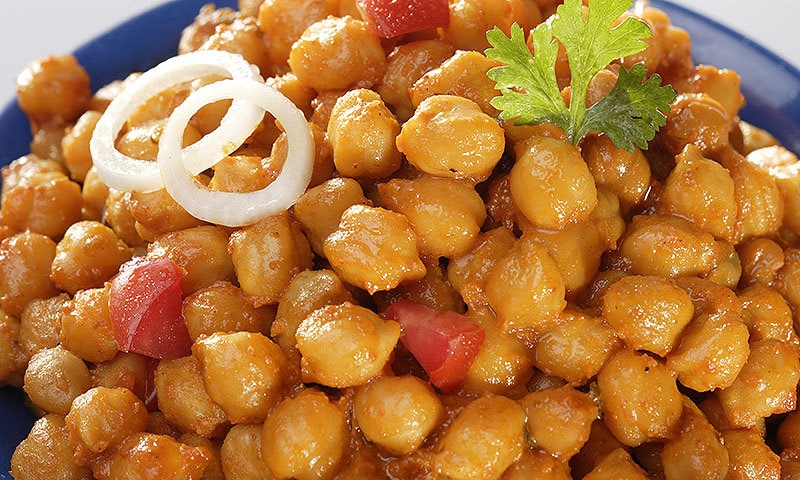 Chaat is topped with chopped tomatoes, onions, green chillie and boiled potatoes. —Creative commons