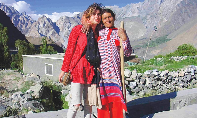 A Hussaini woman poses with a tourist from Karachi