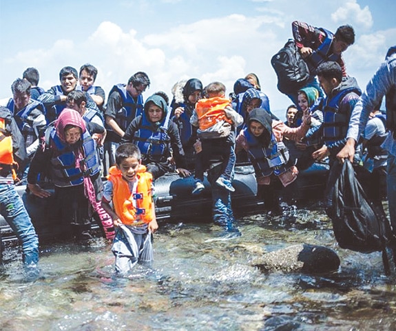 Refugees getting off the boat after landing at Kos, Greece