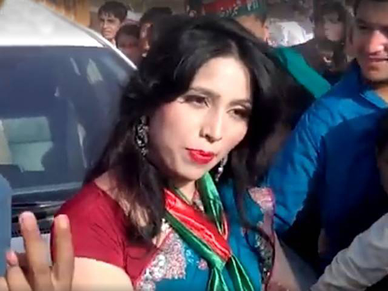 An erroneous lady in a sari at a political rally, making innocent men go wayward.
