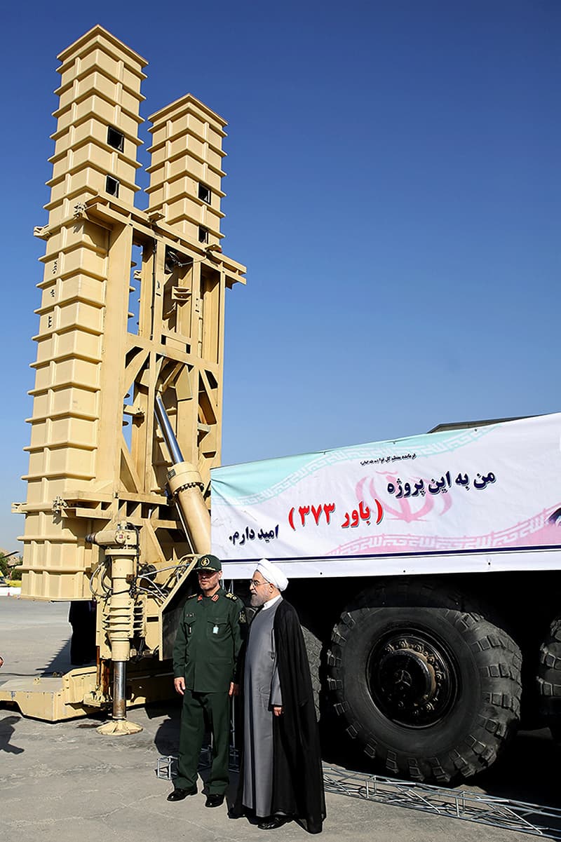TEHRAN: Iranian President Hassan Rouhani and Defence Minister Hossein Dehghan (left) stand beside the new missile defence system on Sunday.—AFP