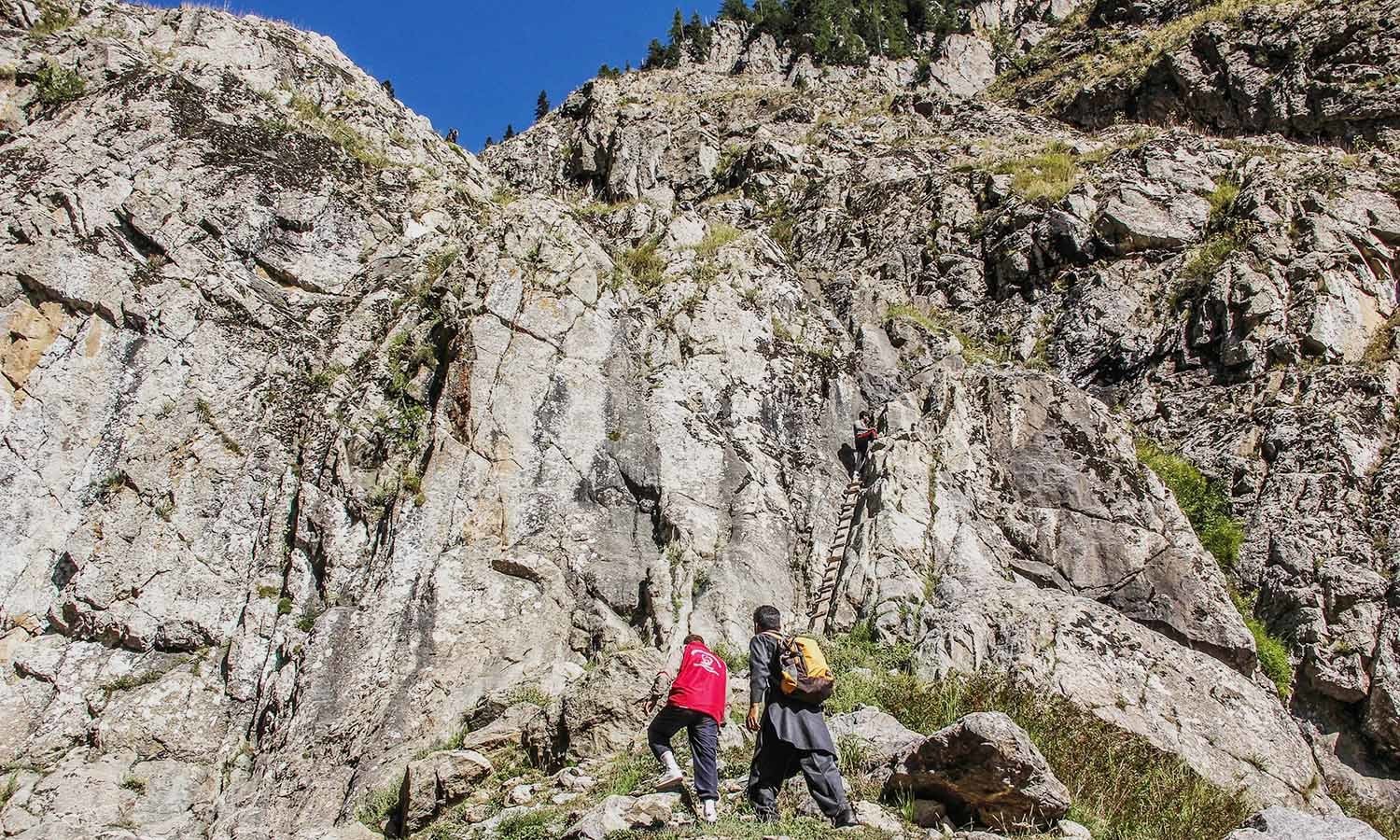 Trekkers make their way up the mountains to reach Godar Lake.