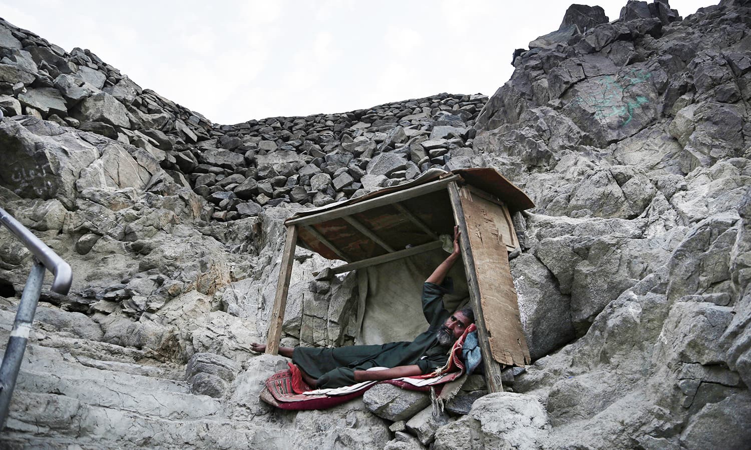 A Pakistani beggar who sleeps on Noor Mountain poses for a portrait.— AP
