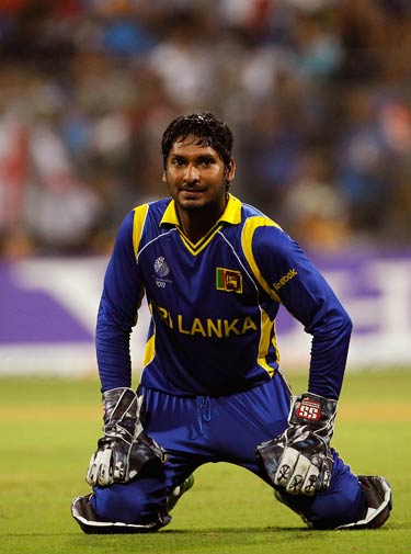 Kumar Sangakkara falls to his knees after he fails to stop a ball. ? Photo by AP