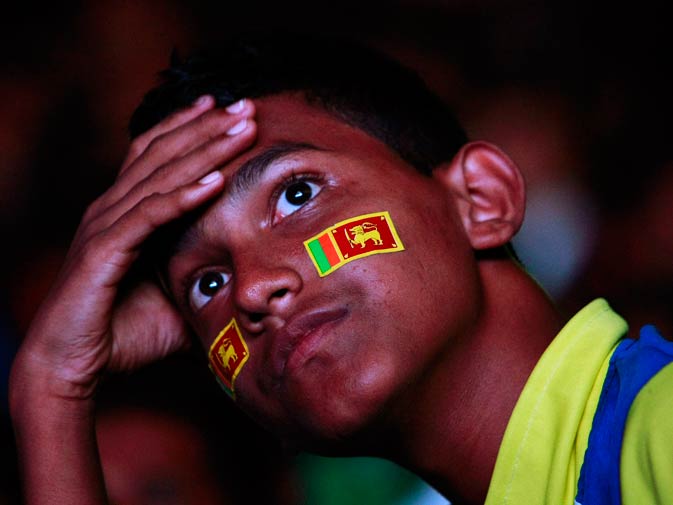 A fan of the Sri Lanka team reacts as he watches the live match on TV. ? Photo by Reuters