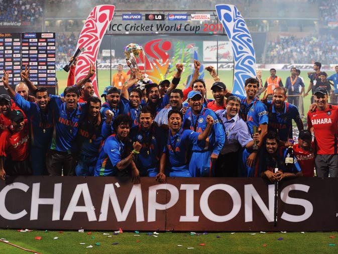 Indian cricketers pose with the trophy after victory in the Cricket World Cup 2011. ? Photo by AFP