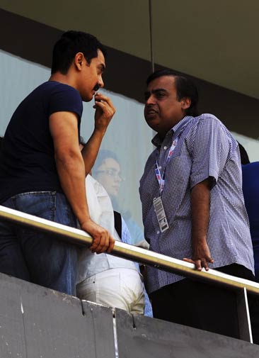 Indian actor Aamir Khan (L) and industrialist Mukesh Ambani interact in the stands during the match. ? Photo by AFP