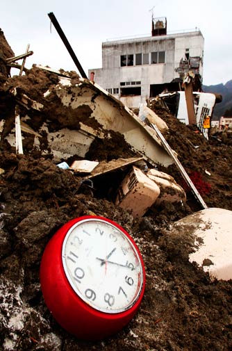 A broken clock sits in the debris on Monday, two hours before the recent earthquake struck Japan at 5.16 pm. – Photo by AP