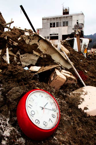 A broken clock sits in the debris on Monday, two hours before the recent earthquake struck Japan at 5.16 pm. – Photo by AP