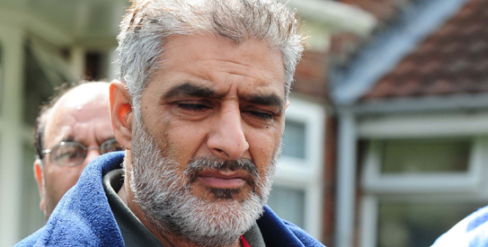 Tarmiq Jahan holds a picture of his son Haroon Jahan after he was killed killed by a car along with two other men in the Winson Green area of Birmingham