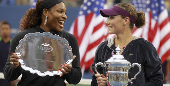 Serena Williams of the U.S. and Samantha Stosur of Australia chat as they hold their trophies after Stosur defeated Williams to win the final of the U.S. Open tennis tournament in New York