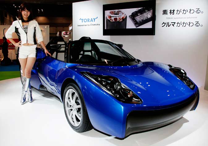 A model poses by Toray's concept Electric Vehicle (EV) "TEEWAVE AR1" at the Tokyo Motor Show in Tokyo, Wednesday, Nov. 30, 2011. ? AP Photo