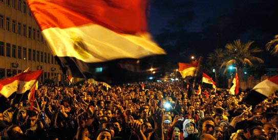Demonstrators wave Egyptian flags as they shout slogans against the military council during a mass protest. - Reuters Photo