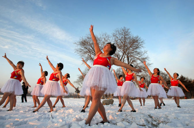 A group of Chinese elderly women dancers gathering to practice their routine on a snow-covered lake in Changchun, in northeast China's Jilin province. Winter activities are especially popular amongst the elderly and retired as they are believed to improve circulation and benefit health, increase the level of mental awareness, release stress, remove aches and pains, increase vitality and keep skin looking younger - and of course, an overall feeling of well-being. ? AFP Photo.