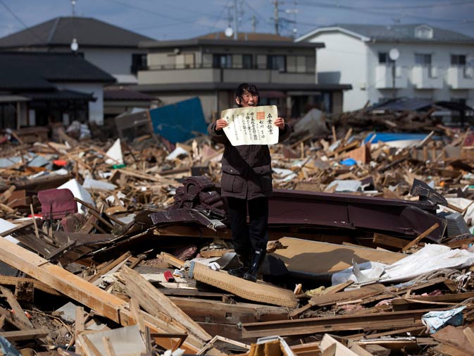 Yasuyoshi Chiba of Japan, a photographer working for Agence France-Presse, has won the first prize People in the News Stories with the ?Aftermath of the tsunami? series. Chieko Matsukawa shows her daughter's graduation certificate as she finds it in the debris in Higashimatsushima city, Miyagi prefecture, Japan April 3, 2011. ? Reuters/Yasuyoshi Chiba/Agence France-Presse/Handout