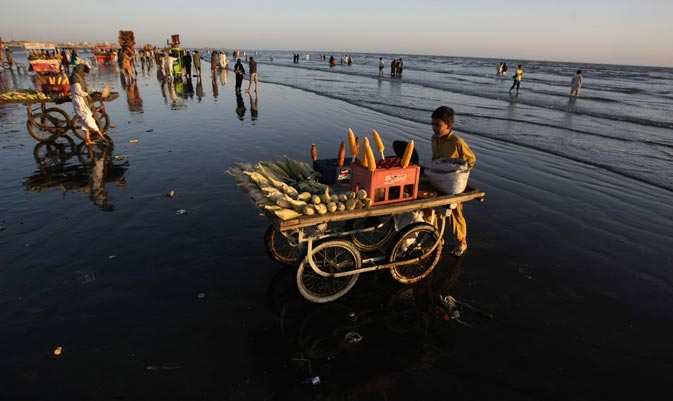 A Pakistani vendor sells corn at a beach in Karachi, Pakistan, Friday, March 9, 2012.