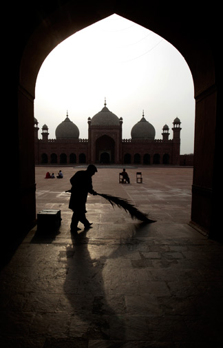 A man sweeps courtyard of Pakistan's historical Badshahi mosque in Lahore, Pakistan on Monday, March 12, 2012. ?AP Photo