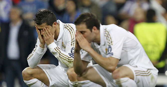 Real Madrid's Ronaldo and Higuain react during the penalty shootout of their Champions League soccer semi-final in Madrid